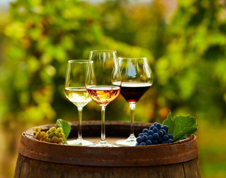 Three,Glasses,Of,Wine,On,A,Wooden,Barrel,In,The